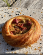 Pastry with fruit filling on a speckled surface