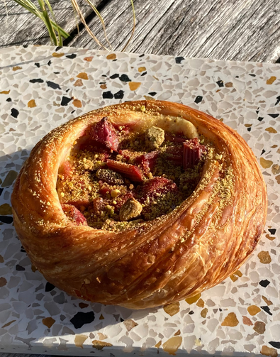 Pastry with fruit filling on a speckled surface